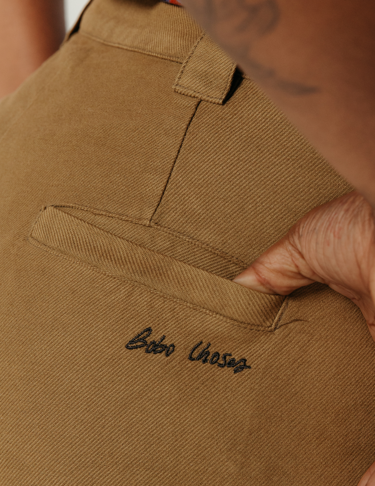 Close-up of a brown pant with 'Bobo Choses embroidery